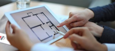 Hände zeigen auf das iPad mit dem Jøtul-Katalog